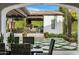 Luxurious outdoor kitchen and dining area with a covered patio and manicured landscaping at 7533 N 70Th St, Paradise Valley, AZ 85253