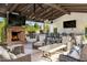 Outdoor entertaining area featuring a stone fireplace, built-in grill, TV and bar seating at 7533 N 70Th St, Paradise Valley, AZ 85253
