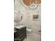 Chic powder room with a decorative chandelier, modern vessel sink, and round mirror for a touch of elegance at 7533 N 70Th St, Paradise Valley, AZ 85253