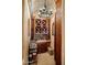 Rustic wine cellar featuring custom wood shelving, a brick barrel ceiling, and decorative chandelier lighting at 7533 N 70Th St, Paradise Valley, AZ 85253