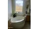 Spa-like bathroom with a large soaking tub and mountain views at 11519 E Blue Wash Rd, Cave Creek, AZ 85331