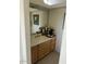 Bathroom boasts a vanity with wood cabinets and a large mirror at 11519 E Blue Wash Rd, Cave Creek, AZ 85331