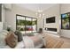 Main bedroom with fireplace, sliding doors to patio, and large TV at 6554 N 40Th Pl, Paradise Valley, AZ 85253