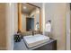 Stylish bathroom with a contemporary sink and wooden mirror frame at 41327 N 106Th St, Scottsdale, AZ 85262