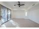 Spacious bedroom with carpeted floors and sliding glass doors leading to a patio at 41327 N 106Th St, Scottsdale, AZ 85262