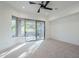 Well-lit bedroom featuring a ceiling fan and patio access at 41327 N 106Th St, Scottsdale, AZ 85262