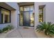 Modern front door entrance with a welcome mat and potted plants at 41327 N 106Th St, Scottsdale, AZ 85262
