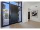 Bright entryway with a large black door and art piece at 41327 N 106Th St, Scottsdale, AZ 85262