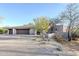 Desert landscape with a three-car garage and stucco home at 41327 N 106Th St, Scottsdale, AZ 85262