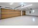 Spacious two-car garage with light-colored flooring and overhead storage at 41327 N 106Th St, Scottsdale, AZ 85262