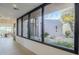 Interior hallway with large windows offering scenic views of the backyard at 41327 N 106Th St, Scottsdale, AZ 85262