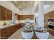 Modern kitchen with wood cabinetry, marble island, and high-end appliances at 41327 N 106Th St, Scottsdale, AZ 85262