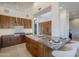 Modern kitchen with marble island, wood cabinets, and breakfast bar at 41327 N 106Th St, Scottsdale, AZ 85262