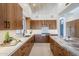 Modern kitchen with wood cabinets, quartz countertops, and island at 41327 N 106Th St, Scottsdale, AZ 85262