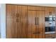 Modern kitchen with built-in appliances and wood cabinets at 41327 N 106Th St, Scottsdale, AZ 85262