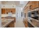 Modern kitchen with wood cabinets, high-end appliances and a built in oven at 41327 N 106Th St, Scottsdale, AZ 85262
