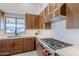 Modern kitchen with wood cabinets, quartz countertops, and high-end appliances at 41327 N 106Th St, Scottsdale, AZ 85262
