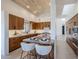 Modern kitchen with wood cabinets, marble countertops and island seating at 41327 N 106Th St, Scottsdale, AZ 85262