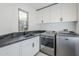 Bright laundry room, featuring washer, dryer, and modern cabinetry at 41327 N 106Th St, Scottsdale, AZ 85262