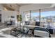 Open living room with sectional sofa and large windows overlooking the backyard at 41327 N 106Th St, Scottsdale, AZ 85262