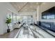 Living room boasts a cozy atmosphere with large windows and fireplace at 41327 N 106Th St, Scottsdale, AZ 85262