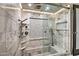 Luxurious glass-enclosed shower with marble tile, built-in niche and rainfall shower head at 8094 E Via Del Vencino --, Scottsdale, AZ 85258