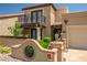 Inviting front entrance with a tiled roof, decorative brick wall, iron gate, and manicured landscaping at 8094 E Via Del Vencino --, Scottsdale, AZ 85258