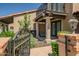 Stylish front porch featuring stone pillars, an iron gate, beautiful landscaping, and seating at 8094 E Via Del Vencino --, Scottsdale, AZ 85258