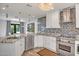Open kitchen with stainless steel appliances, granite counters, tile backsplash, and a view to the backyard at 8094 E Via Del Vencino --, Scottsdale, AZ 85258
