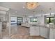 Open floor plan with fireplace, wood look floors, a view to the kitchen, and sliding glass doors to the backyard at 8094 E Via Del Vencino --, Scottsdale, AZ 85258