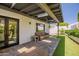 Inviting covered patio with stone pavers, comfortable seating, and a well-maintained artificial lawn at 8094 E Via Del Vencino --, Scottsdale, AZ 85258