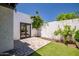 Enclosed patio featuring stone pavers, artificial lawn, and freshly-textured stucco walls, providing a private outdoor space at 8094 E Via Del Vencino --, Scottsdale, AZ 85258