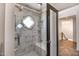 Luxurious bathroom with a glass-enclosed shower and marble tile surround, featuring a built-in bench at 8094 E Via Del Vencino --, Scottsdale, AZ 85258