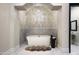 Luxurious bathroom featuring a freestanding tub, chandelier, decorative tile, and arched alcove at 6112 E Quartz Mountain Rd, Paradise Valley, AZ 85253