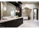 Elegant bathroom with marble countertop, dark wood cabinets, decorative lighting, and soaking tub with decorative tile at 6112 E Quartz Mountain Rd, Paradise Valley, AZ 85253