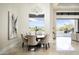 Sunlit dining area with mountain views, chandelier, and round table with seating for six at 6112 E Quartz Mountain Rd, Paradise Valley, AZ 85253