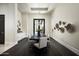 Modern dining room with a long black table, seating for ten, and stylish decor at 6112 E Quartz Mountain Rd, Paradise Valley, AZ 85253
