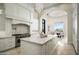 Spacious kitchen with a large island, stainless steel appliances, and a view into the dining area at 6112 E Quartz Mountain Rd, Paradise Valley, AZ 85253