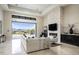 Bright living room features sliding doors to patio and backyard, fireplace and tile floors at 6112 E Quartz Mountain Rd, Paradise Valley, AZ 85253