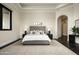 Serene main bedroom with tufted headboard, dark wood floors, and a neutral color palette at 6112 E Quartz Mountain Rd, Paradise Valley, AZ 85253