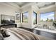 Bright main bedroom with dark wood floors, sitting area, and mountain views from multiple windows at 6112 E Quartz Mountain Rd, Paradise Valley, AZ 85253
