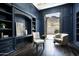 Elegant office featuring custom blue built-ins, stylish furniture, and views of the outdoors at 6112 E Quartz Mountain Rd, Paradise Valley, AZ 85253