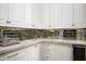 Stylish wet bar with white cabinets, marble countertops, mirrored backsplash, and a wine fridge at 6112 E Quartz Mountain Rd, Paradise Valley, AZ 85253