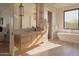 Bright bathroom with dual sinks, stand alone tub, glass enclosed shower and natural light at 36421 N 105Th Pl, Scottsdale, AZ 85262