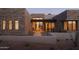 Contemporary home entrance with stone accents, glass doors, and desert landscaping, creating curb appeal at 36421 N 105Th Pl, Scottsdale, AZ 85262