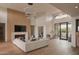 Elegant living room boasts a fireplace, wood floors, and large windows, creating a cozy atmosphere at 36421 N 105Th Pl, Scottsdale, AZ 85262