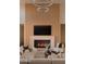 Stylish living room featuring a fireplace, wood paneling, and modern lighting fixtures at 36421 N 105Th Pl, Scottsdale, AZ 85262