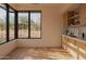 Bright living room features built-in cabinets, wood floors and views of landscaped exterior at 36421 N 105Th Pl, Scottsdale, AZ 85262