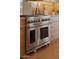 Gourmet kitchen featuring a stainless steel Wolf oven and hardwood floors at 36421 N 105Th Pl, Scottsdale, AZ 85262