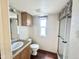 Bathroom with wood cabinets, modern fixtures, and walk-in shower at 1044 S Quartz Dr, Apache Junction, AZ 85119